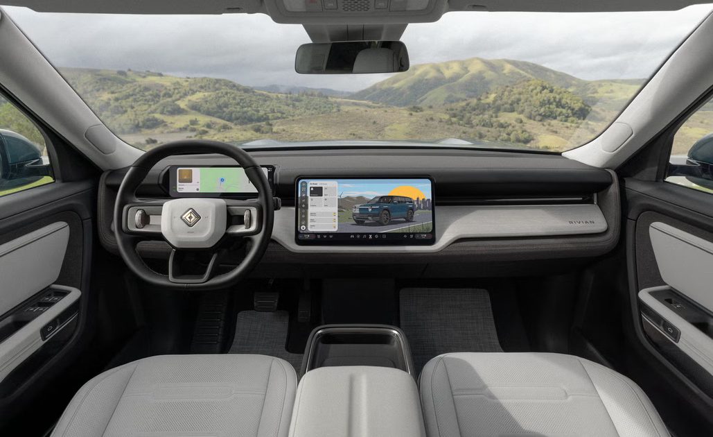 vehicle interior with steering wheel, digital instrument cluster, center touchscreen, light seats.